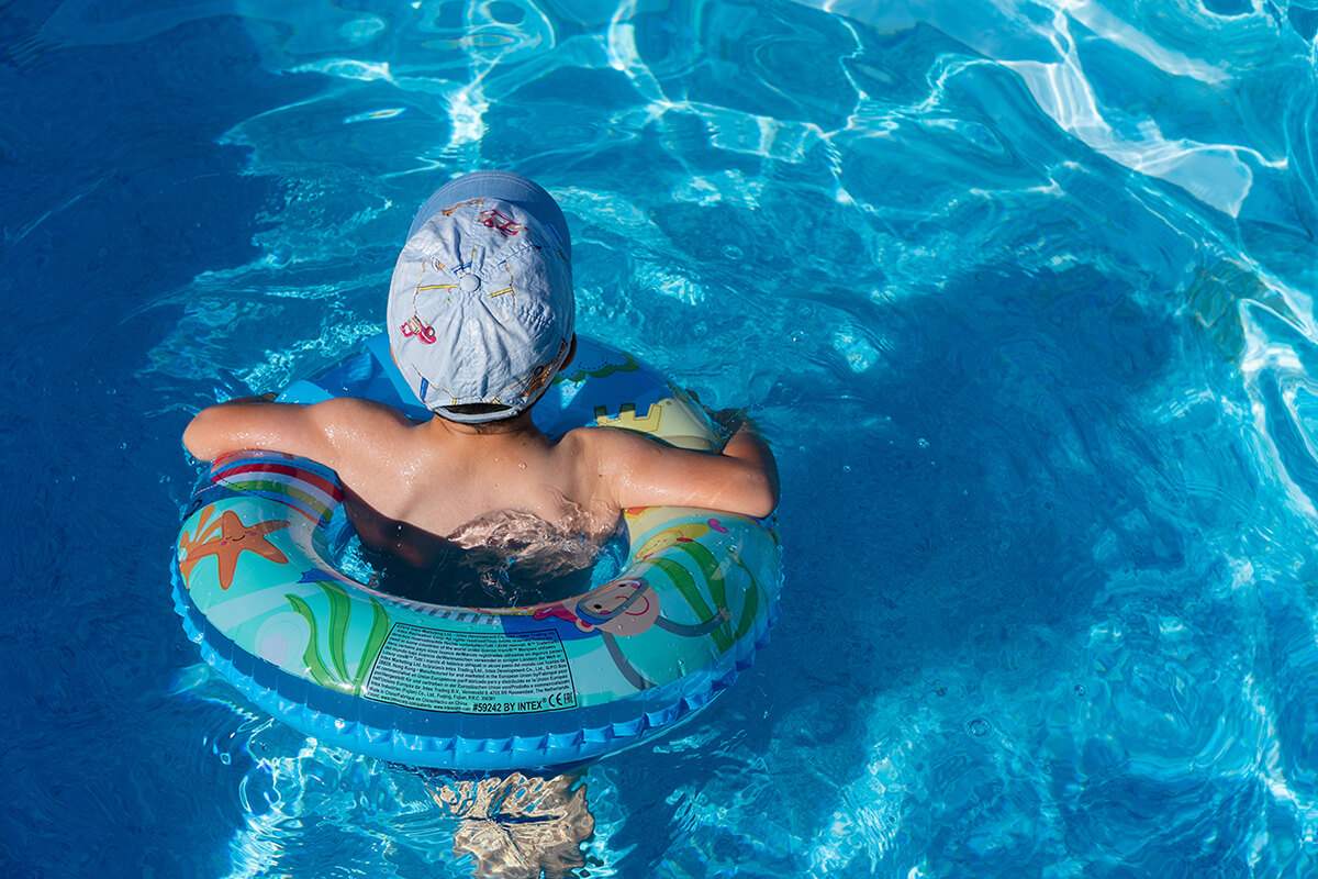 kid floating and relaxing in the swimming pool